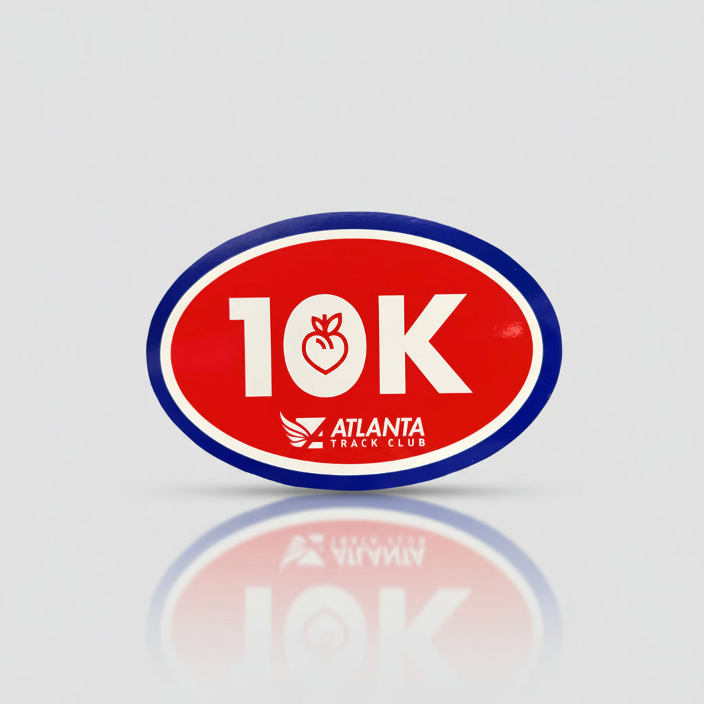A red, white, and blue oval-shaped magnet with '10K' written in white and a small logo that resembles a running track with the words 'Atlanta Track Club'.