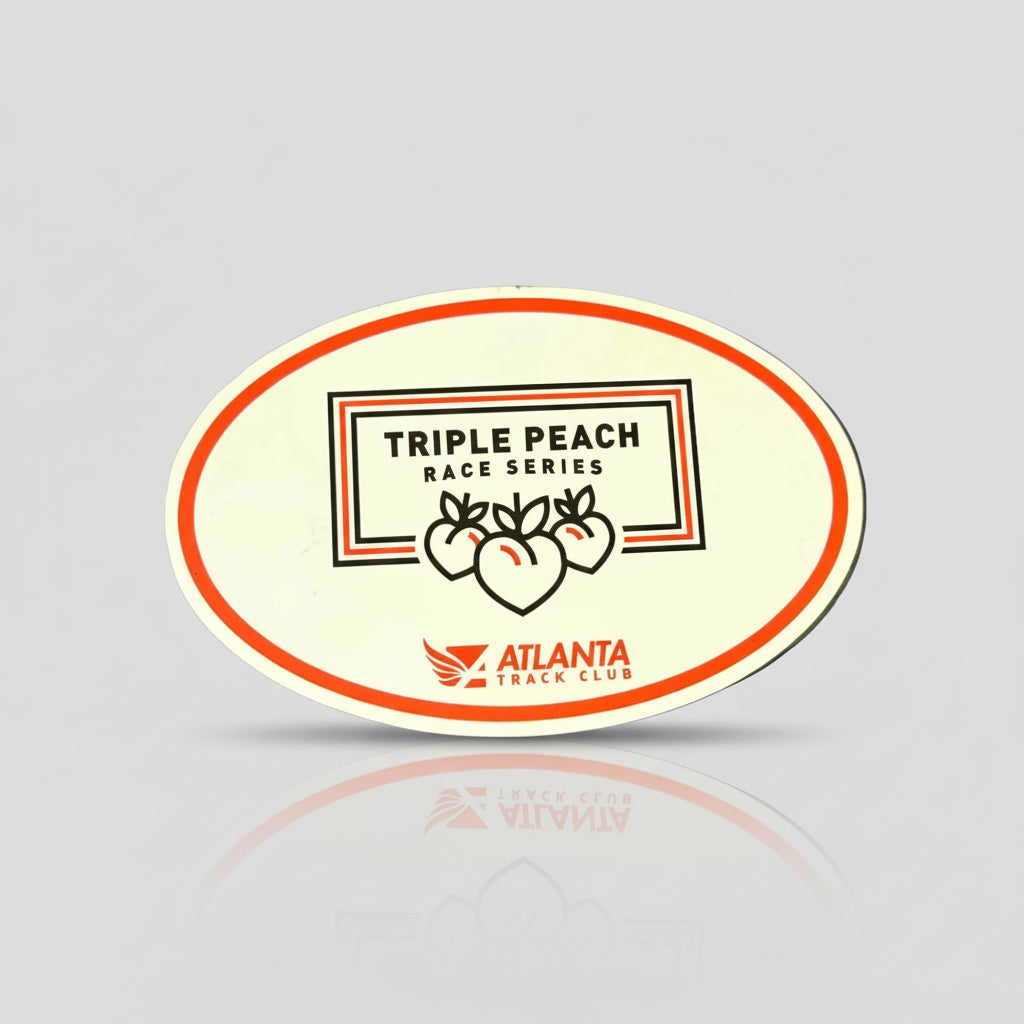 An oval-shaped magnet with white and peach color scheme, featuring the text 'TRIPLE PEACH RACE SERIES' and the Atlanta logo.