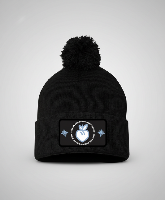 Black beanie with pom-pom and a patch on a white background