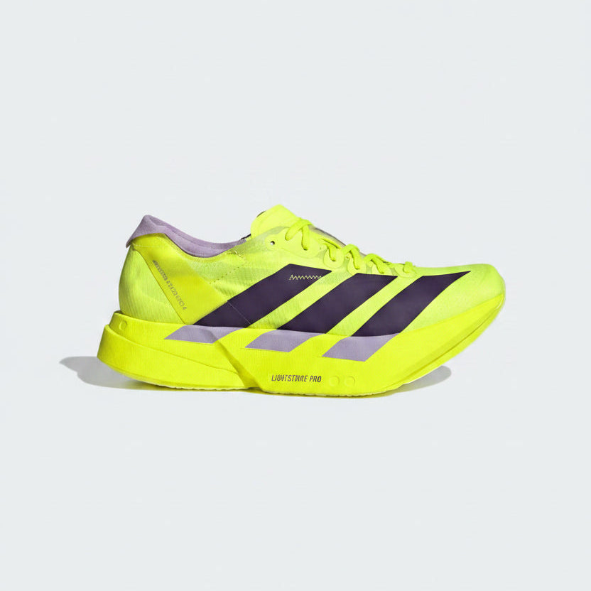 Bright yellow athletic shoe with purple accents on a light gray background