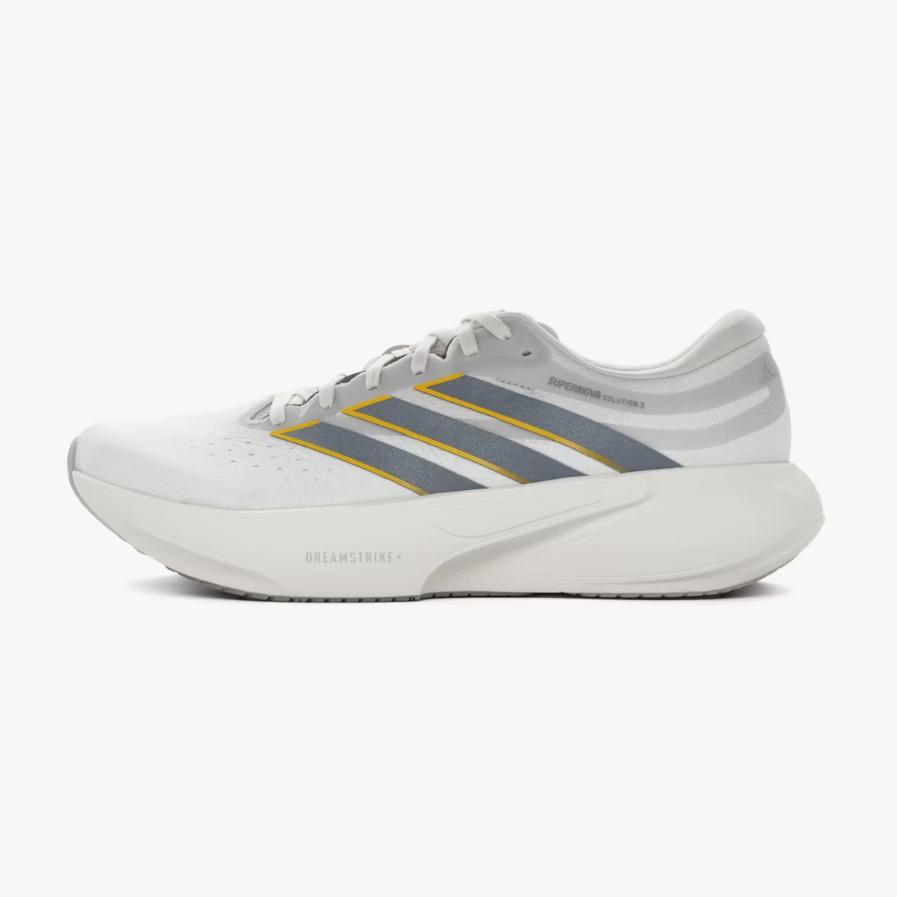 A white Adidas running shoe with gray and yellow stripes, shown in a side profile on a light gray background.