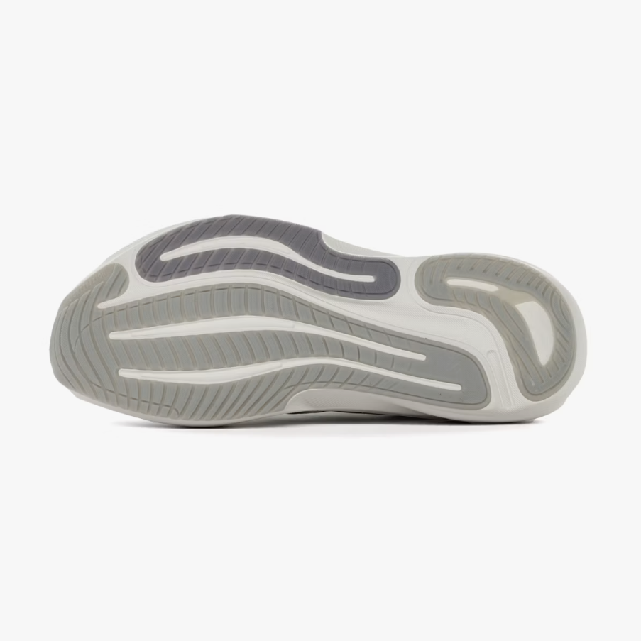 The outsole of a sneaker shown from a top-down view, featuring a layered design in light gray, medium gray, and dark gray on a white background.