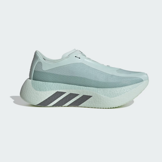 A single Adidas running shoe in a pale mint green colorway, featuring a textured mesh upper, a thick sculpted midsole, and three dark gray stripes on the side, set against a clean light gray background.