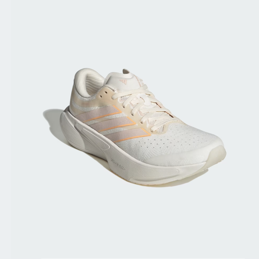 A single Adidas running shoe in off-white with light orange stripes, shown from a three-quarters angle on a light gray background.