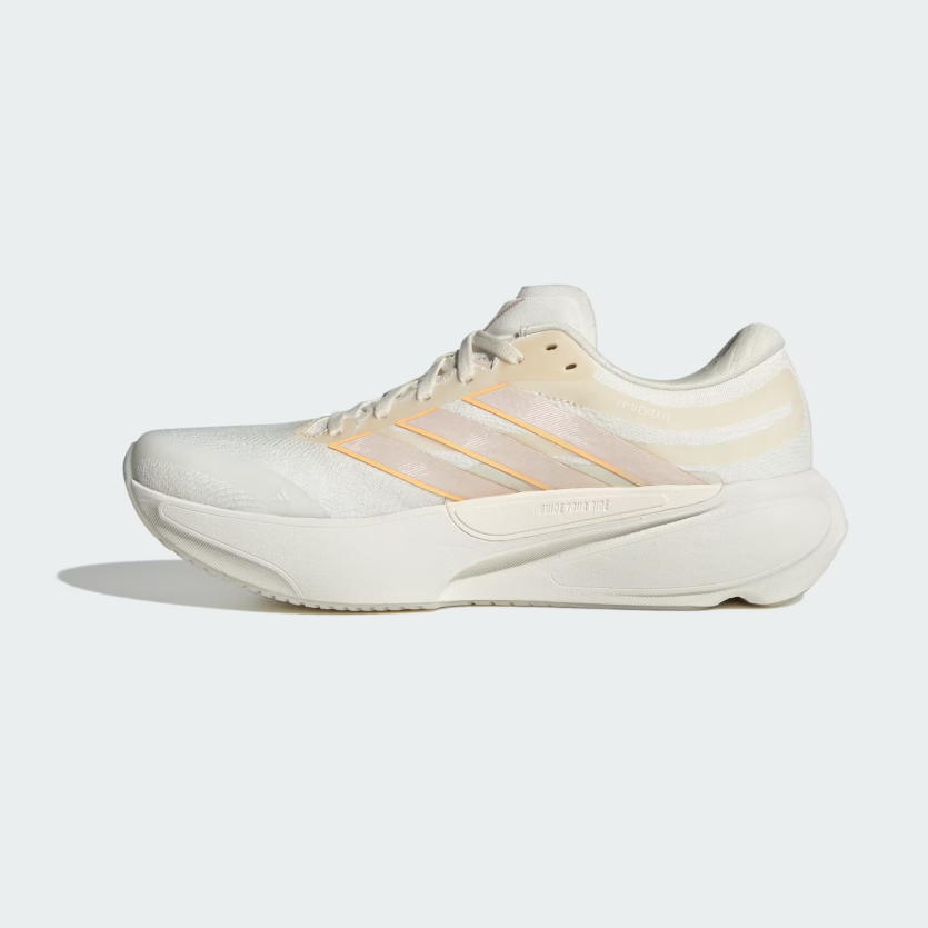 An Adidas running shoe in off-white and beige with subtle gold stripes, shown in a side profile on a light gray background.